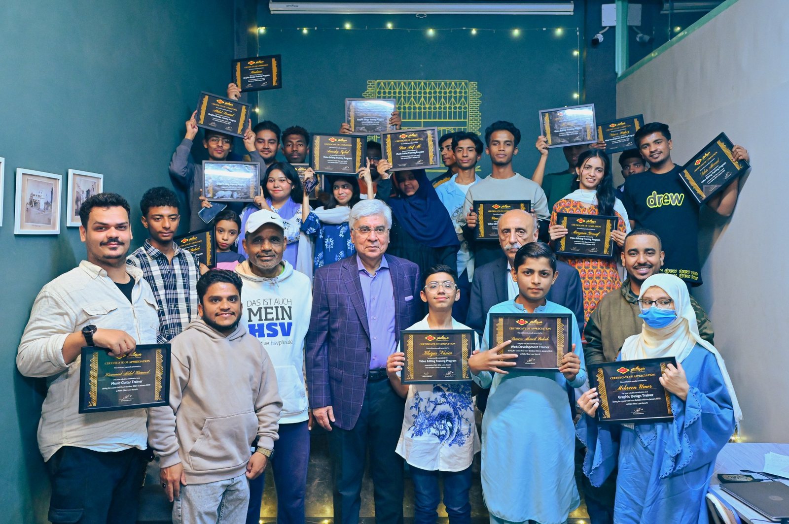 Students receiving certificates after training